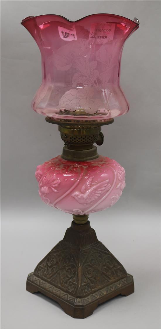 A cranberry shaded oil lamp